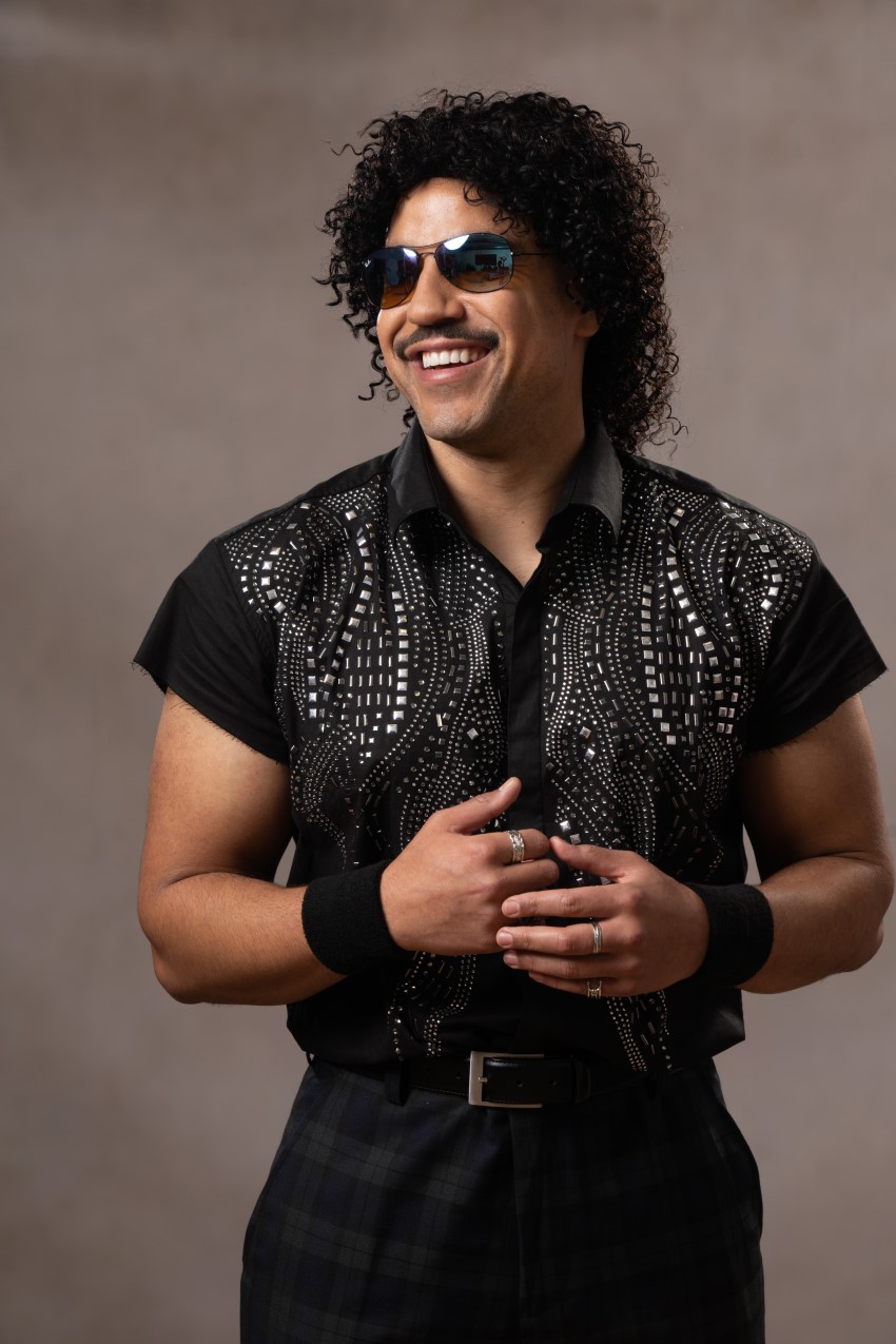 Jack posing as Lionel Richie in a waste coat and sun glasses.