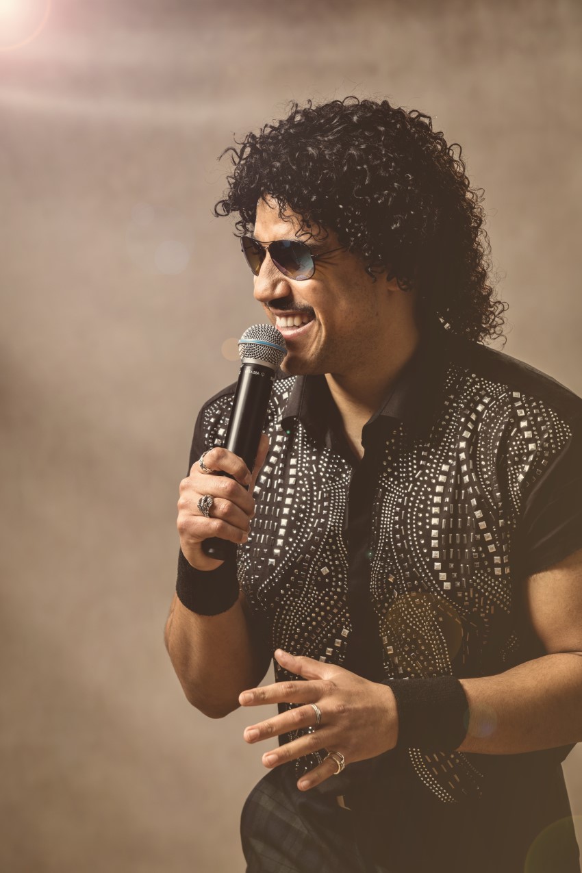 Jack performing as Lionel Richie holding the mic.