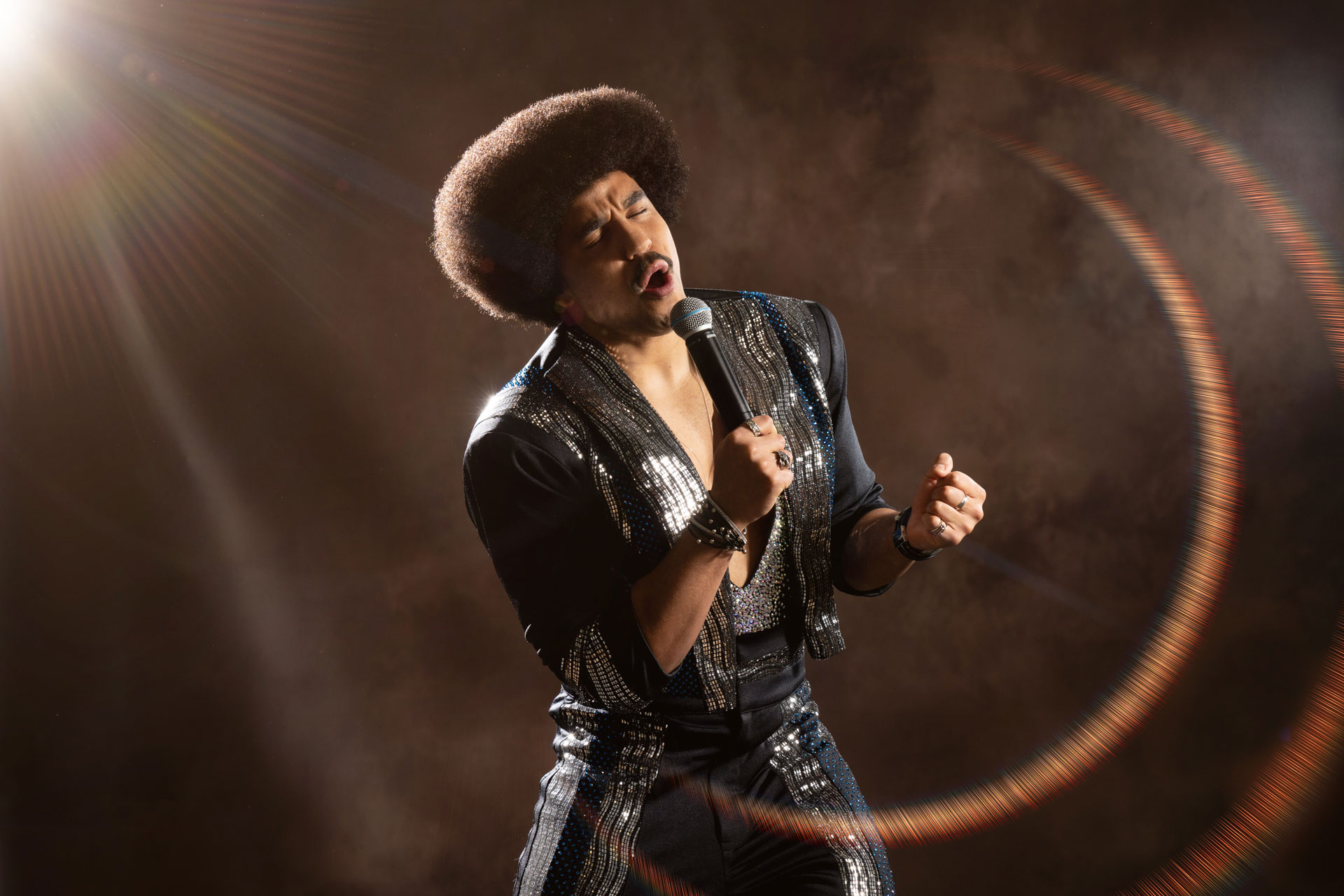 Jack Brindle performing on stage as Lionel Richie